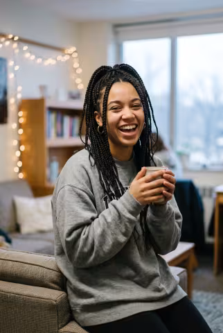 Undergraduate portrait, dormitory common room background — Person `person_portrait`.
